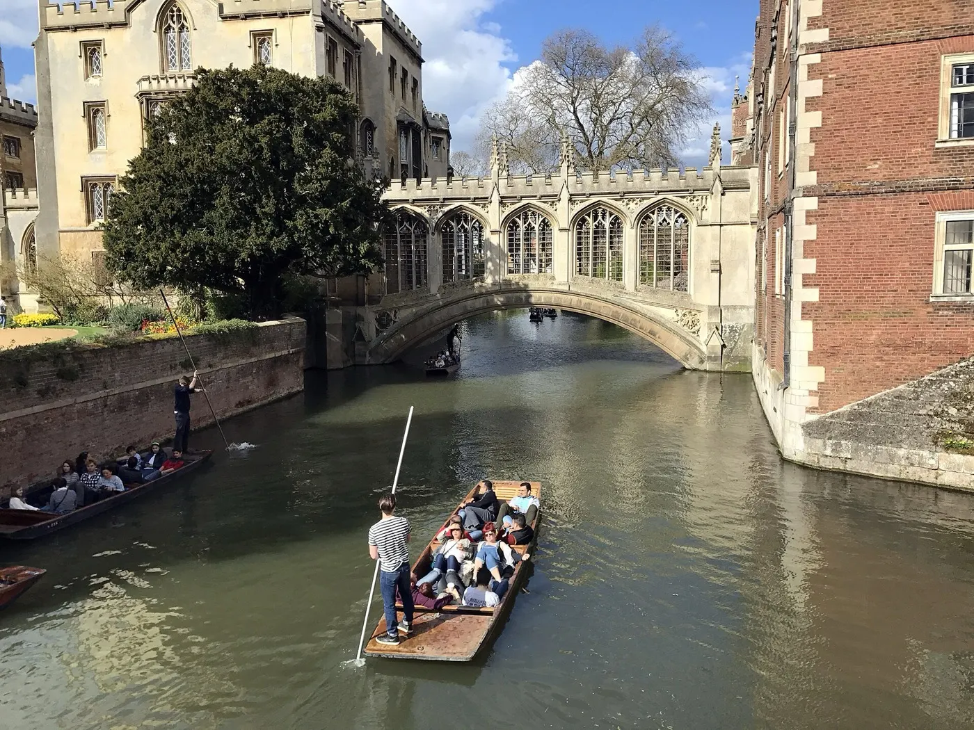 A punt being poled along the Cam near the Bridge of Sighs