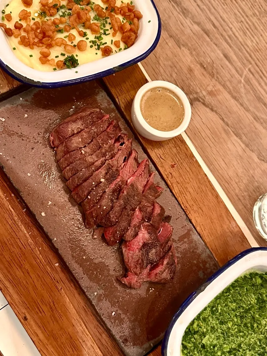 Flat Iron's signature sliced steak with creamy mash and sauce