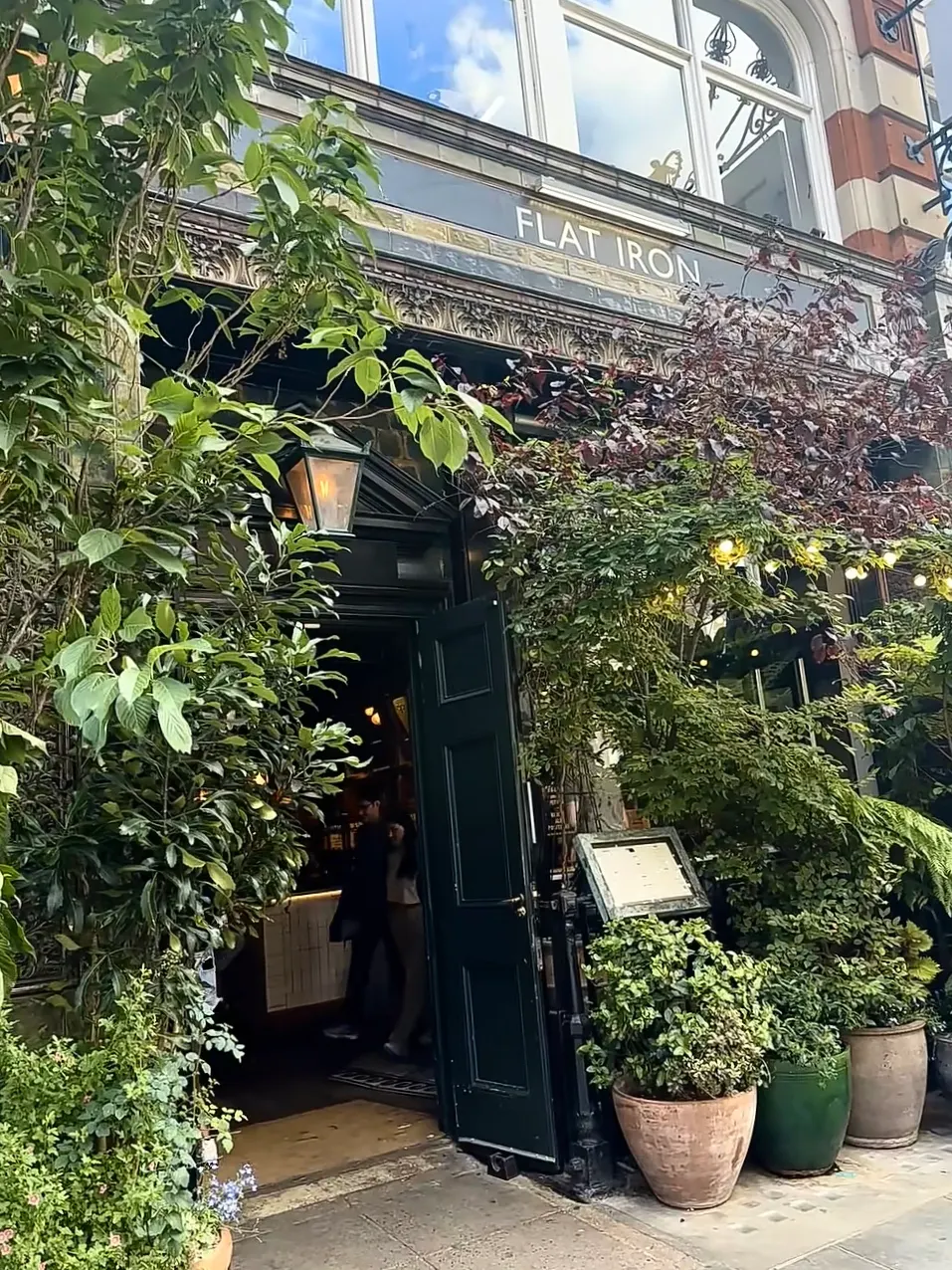 The greenery-framed entrance of Flat Iron