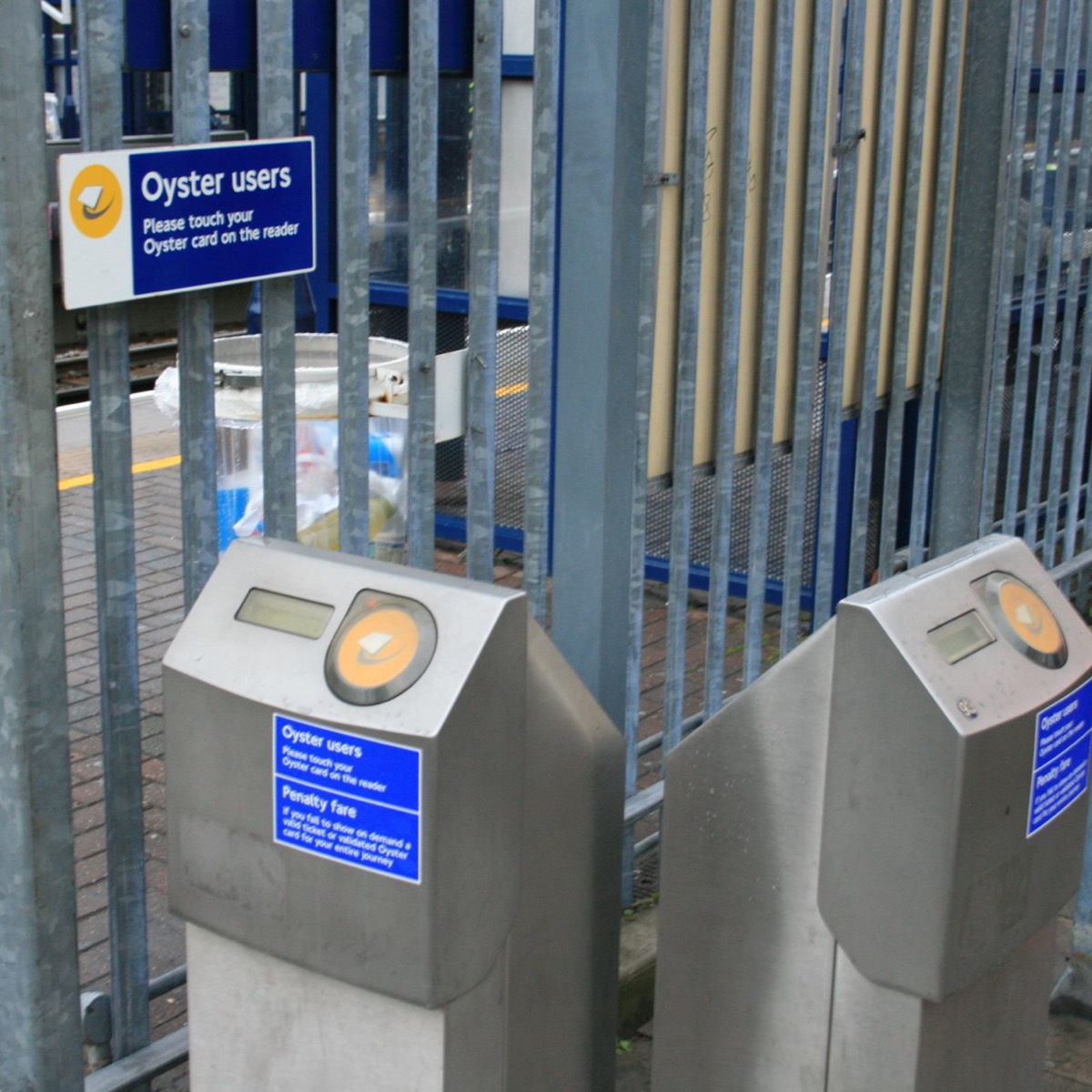 Yellow contactless card readers at a London Underground gate